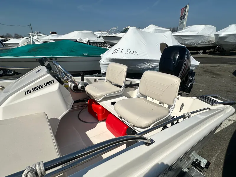 Slide: The Image of 2019 Boston Whaler 130 Super Sport boat at the marina. - 6