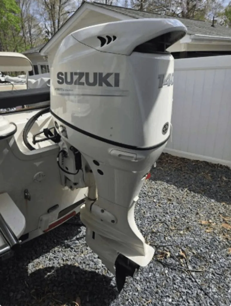 Slide: The Image of Suzuki outboard motor on a 2020 Carolina Skiff 19 LS boat. - 11