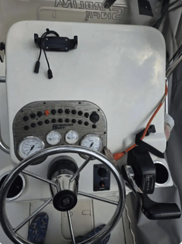 Slide: The Image of 2020 Carolina Skiff 19 LS boat console with steering wheel and gauges. - 3
