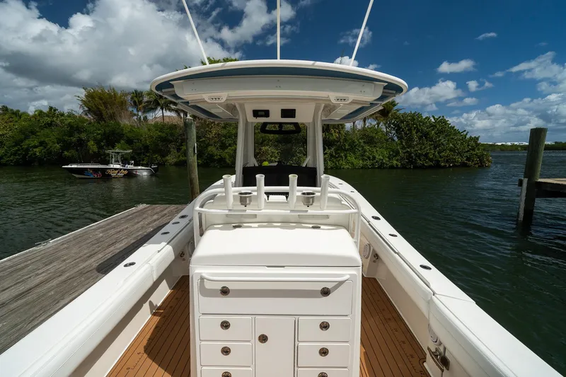 Slide: The Image of 2020 Regulator 31 boat docked on a sunny day, featuring sleek design and spacious deck. - 16