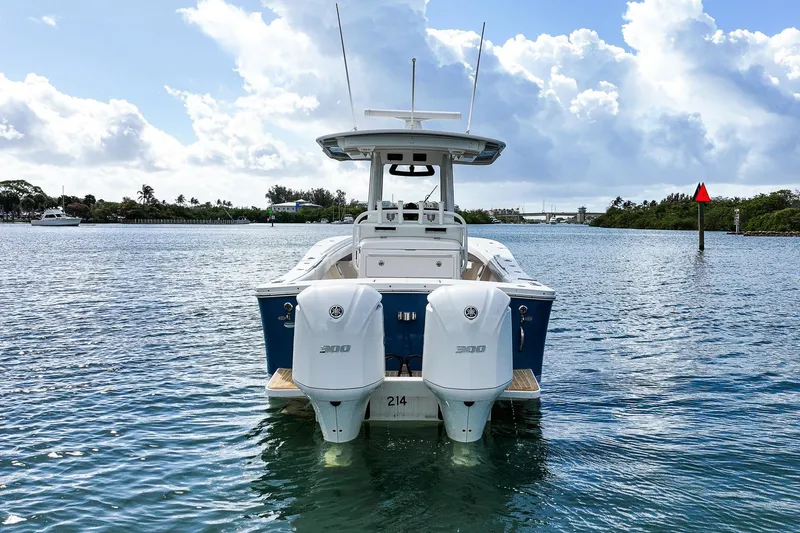 Slide: The Image of 2020 Regulator 31 boat with twin engines on a calm waterway under a cloudy sky. - 2