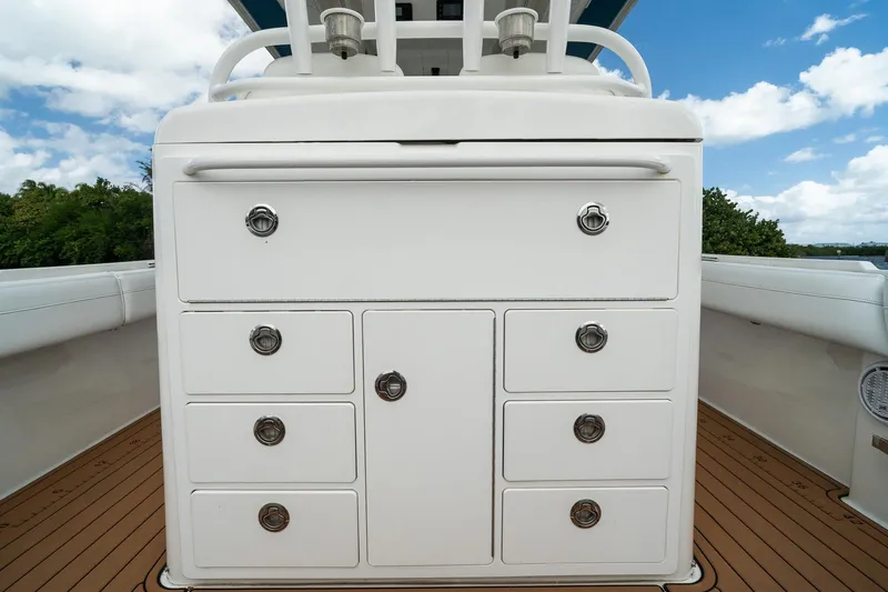Slide: The Image of 2020 Regulator 31 boat interior with white storage drawers on teak deck. - 23