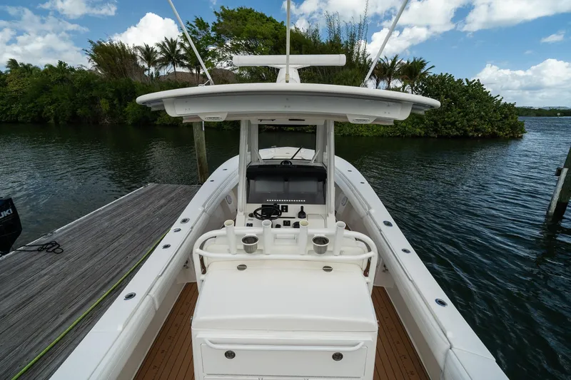 Slide: The Image of 2020 Regulator 31 boat docked by lush greenery and calm waters. - 25