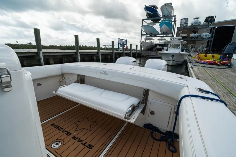 Slide: The Image of 2020 Regulator 31 boat docked, featuring spacious seating and sleek design. - 28