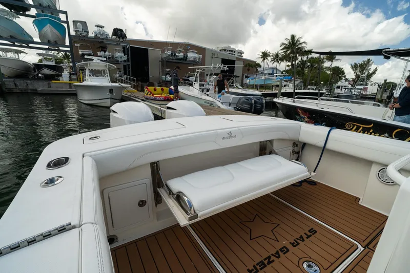 Slide: The Image of 2020 Regulator 31 boat docked at marina with seating and teak flooring. - 29