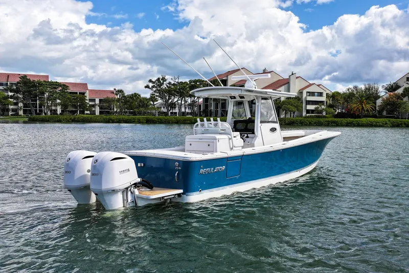Slide: The Image of 2020 Regulator 31 boat with twin Yamaha engines on a scenic waterway. - 3