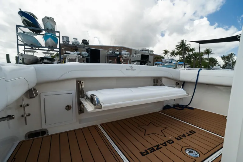 Slide: The Image of 2020 Regulator 31 boat interior with teak flooring and foldable seating. - 30