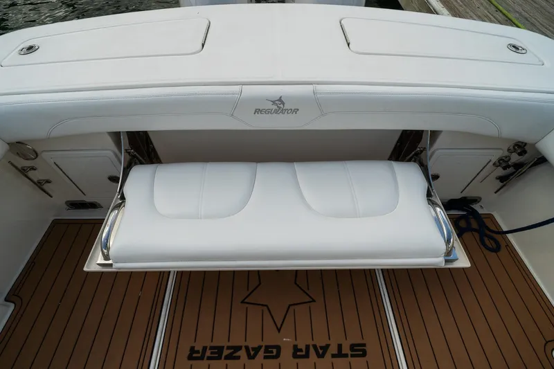 Slide: The Image of 2020 Regulator 31 boat with white cushioned seating and teak flooring. - 31