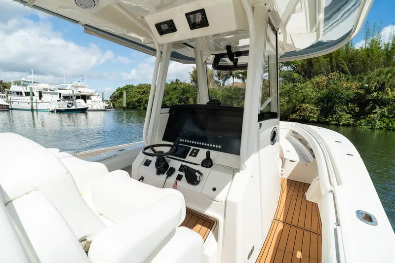 Slide: The Image of 2020 Regulator 31 boat interior with helm, steering wheel, and navigation controls. - 36