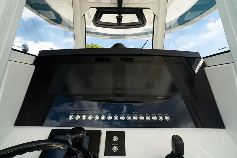 Slide: The Image of 2020 Regulator 31 boat dashboard with Garmin displays and control panel. - 38