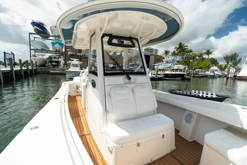 Slide: The Image of 2020 Regulator 31 boat docked at marina, featuring sleek design and spacious seating. - 53