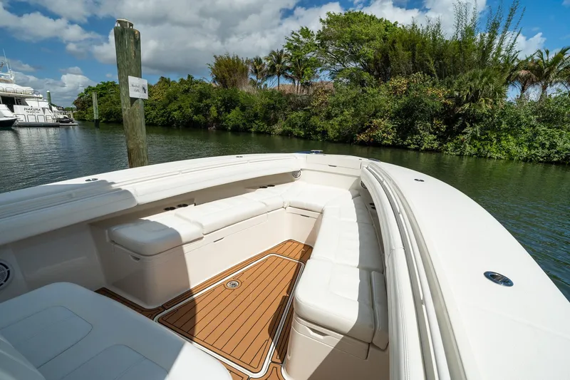Slide: The Image of 2020 Regulator 31 boat with spacious seating, docked near lush greenery. - 58