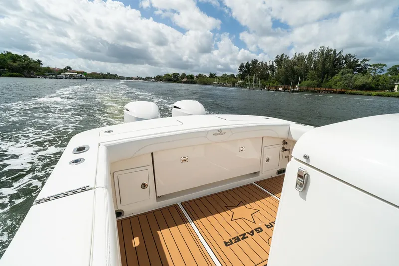 Slide: The Image of 2020 Regulator 31 boat cruising on a scenic waterway under a partly cloudy sky. - 6