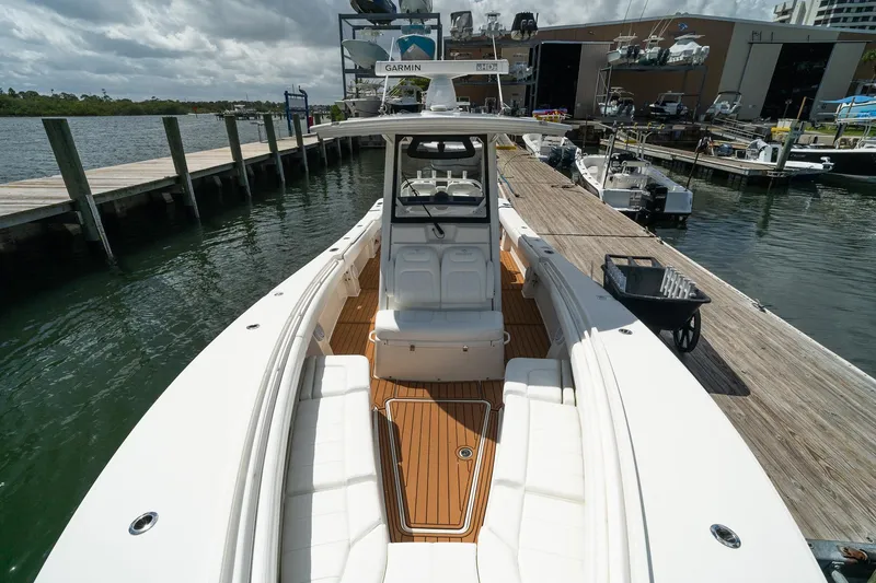 Slide: The Image of 2020 Regulator 31 boat docked at marina, showcasing sleek design and spacious deck. - 60