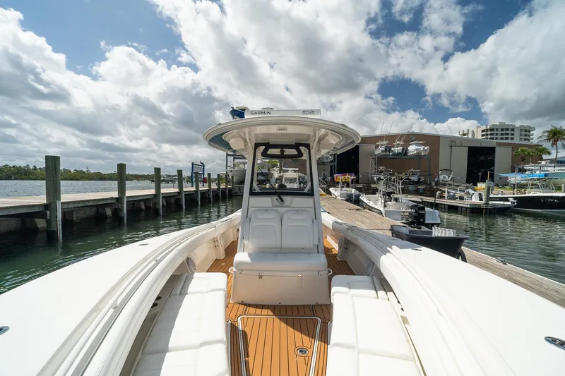 Slide: The Image of 2020 Regulator 31 boat docked at marina under cloudy sky. - 61