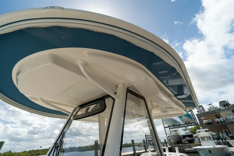 Slide: The Image of 2020 Regulator 31 boat with sleek design, viewed from below against a cloudy sky. - 64