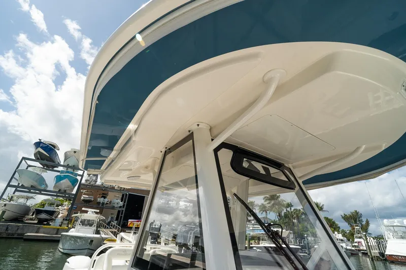 Slide: The Image of 2020 Regulator 31 boat docked, showcasing sleek design and marina background. - 65