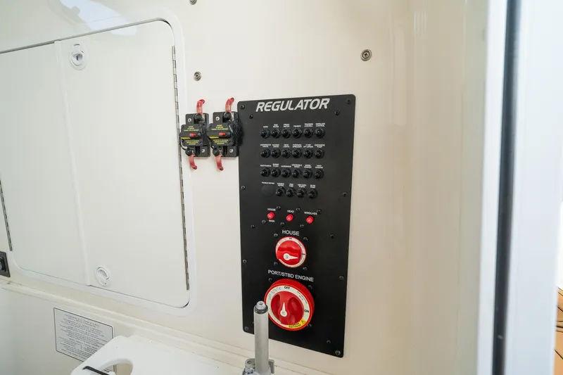 Slide: The Image of Control panel of a 2020 Regulator 31 boat, featuring switches and dials. - 67