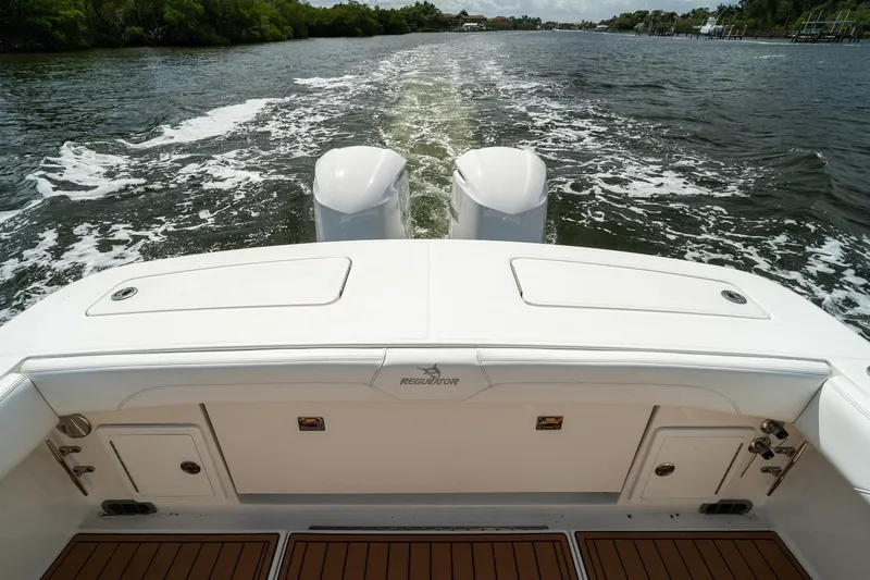 Slide: The Image of 2020 Regulator 31 boat cruising on a scenic waterway with twin engines. - 7