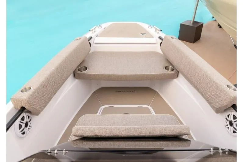 Slide: The Image of 2027 Axopar 22 T-Top boat interior with beige seating and cup holders. - 4