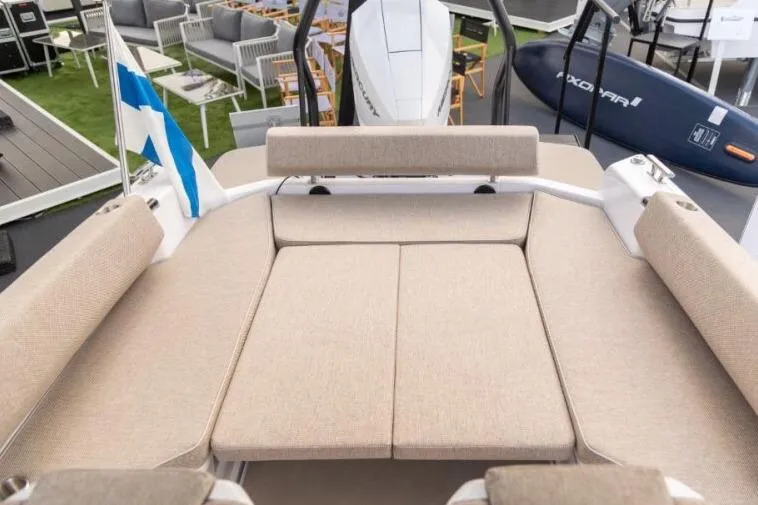 Slide: The Image of 2027 Axopar 22 T-Top boat with beige seating and modern design. - 5