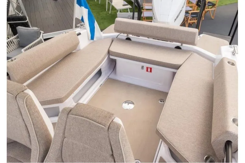 Slide: The Image of 2027 Axopar 22 T-Top boat interior with beige seating and modern design. - 6