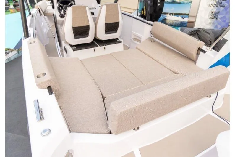 Slide: The Image of 2027 Axopar 22 T-Top boat interior with beige seating and modern design. - 7