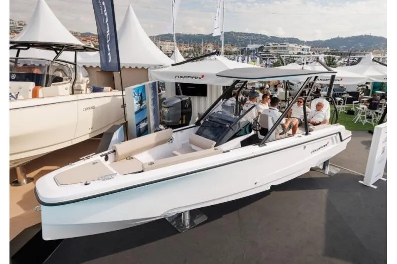 Slide: The Image of 2027 Axopar 22 T-Top boat displayed at a marine exhibition. - 8