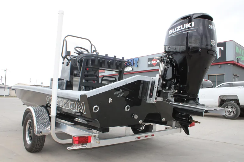 The Image of 2026 Freedom Boats 16' Eagle with Suzuki outboard motor on trailer. - 1