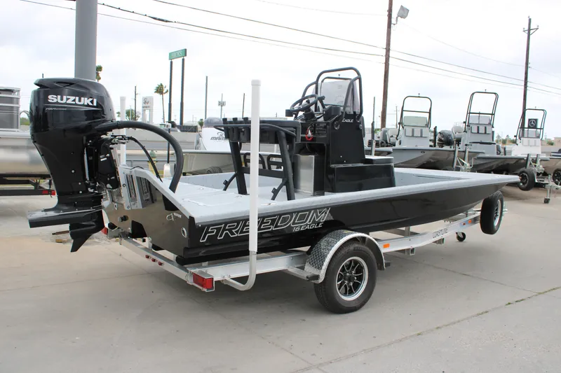 Slide: The Image of 2026 Freedom Boats 16' Eagle with Suzuki outboard motor on trailer. - 14