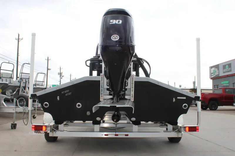 Slide: The Image of 2026 Freedom Boats 16' Eagle with 90 HP engine on trailer, rear view. - 15