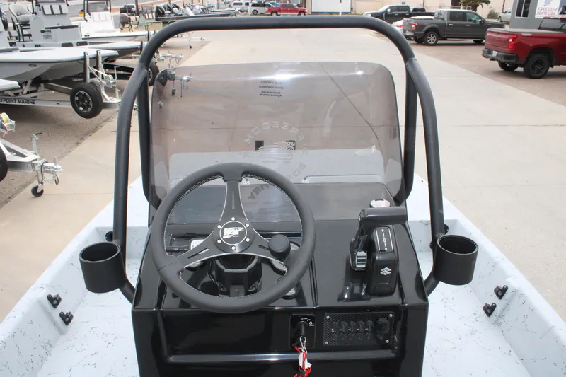 Slide: The Image of 2026 Freedom Boats 16' Eagle dashboard with steering wheel and controls. - 5