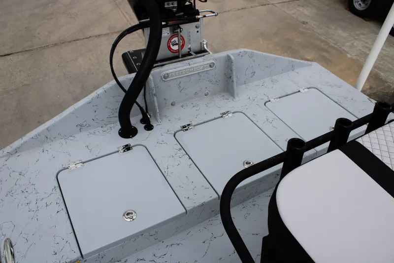 Slide: The Image of 2026 Freedom Boats 16' Eagle deck with storage compartments and seating. - 7