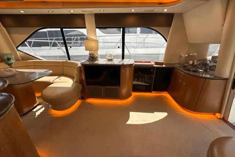 Slide: The Image of Luxurious interior of 1999 Bayliner 5788 Pilot House Motoryacht with elegant seating and ambient lighting. - 12