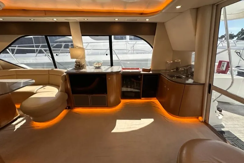 Slide: The Image of Luxurious interior of a 1999 Bayliner 5788 Pilot House Motoryacht with elegant lighting and seating. - 15