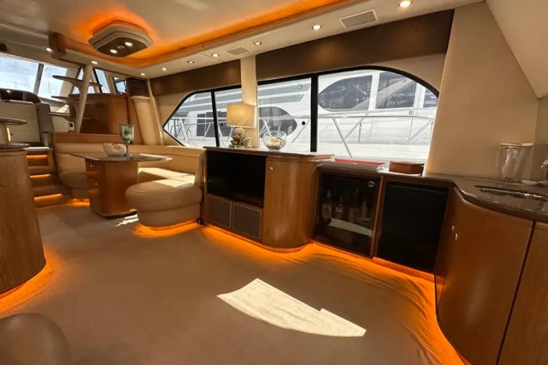 Slide: The Image of Luxurious interior of 1999 Bayliner 5788 Pilot House Motoryacht with elegant lighting and wood finishes. - 16