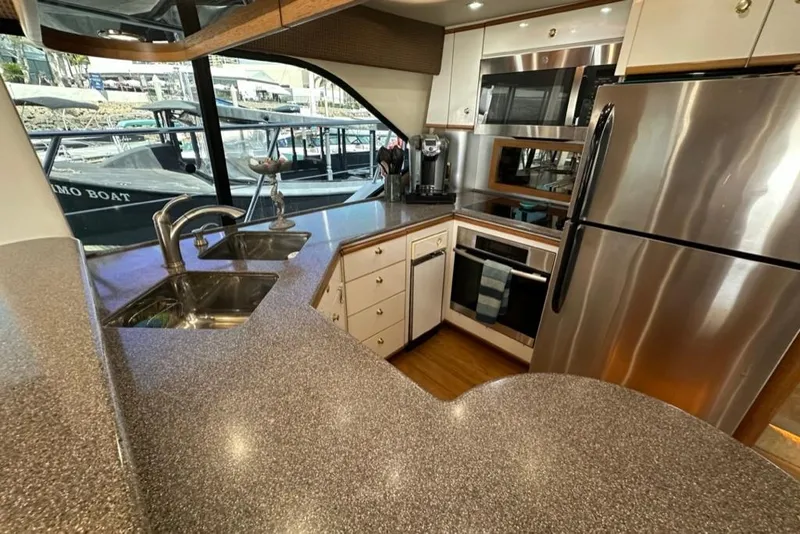 Slide: The Image of Luxurious kitchen interior of 1999 Bayliner 5788 Pilot House Motoryacht with modern appliances. - 22