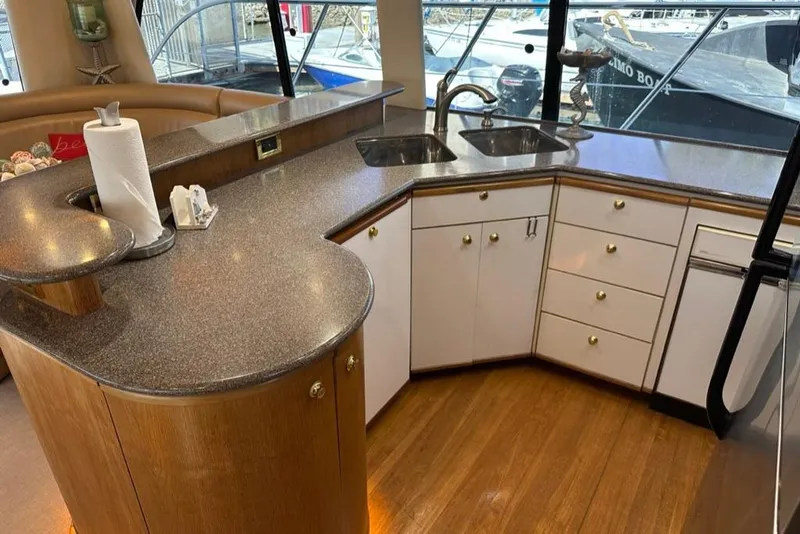 Slide: The Image of Luxurious kitchen interior of 1999 Bayliner 5788 Pilot House Motoryacht with modern countertops. - 23