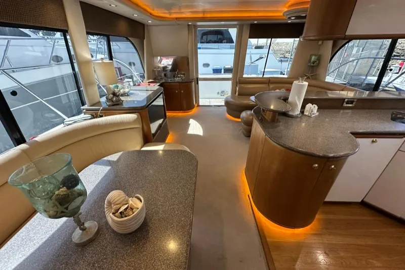 Slide: The Image of Luxurious interior of 1999 Bayliner 5788 Pilot House Motoryacht with elegant furnishings and ambient lighting. - 26