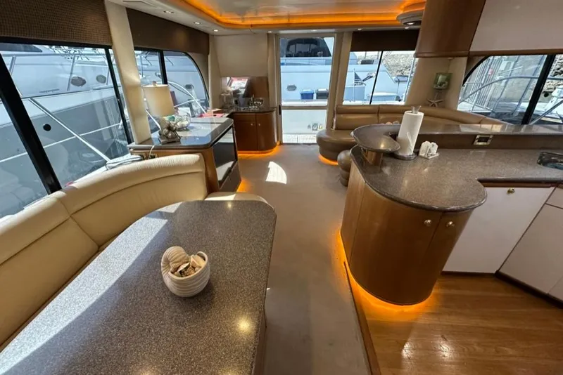 Slide: The Image of Luxurious interior of a 1999 Bayliner 5788 Pilot House Motoryacht with elegant seating and ambient lighting. - 27