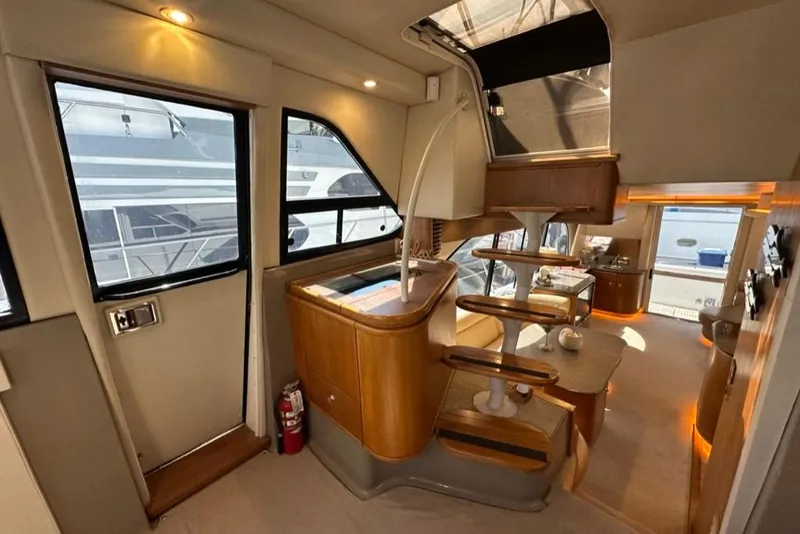 Slide: The Image of Interior of a 1999 Bayliner 5788 Pilot House Motoryacht, featuring elegant wood finishes and modern design. - 28