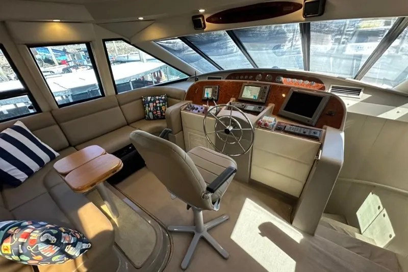 Slide: The Image of 1999 Bayliner 5788 Pilot House Motoryacht interior with helm, seating, and navigation equipment. - 30