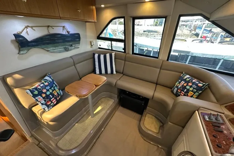 Slide: The Image of Luxurious interior of 1999 Bayliner 5788 Pilot House Motoryacht with cozy seating and nautical decor. - 31