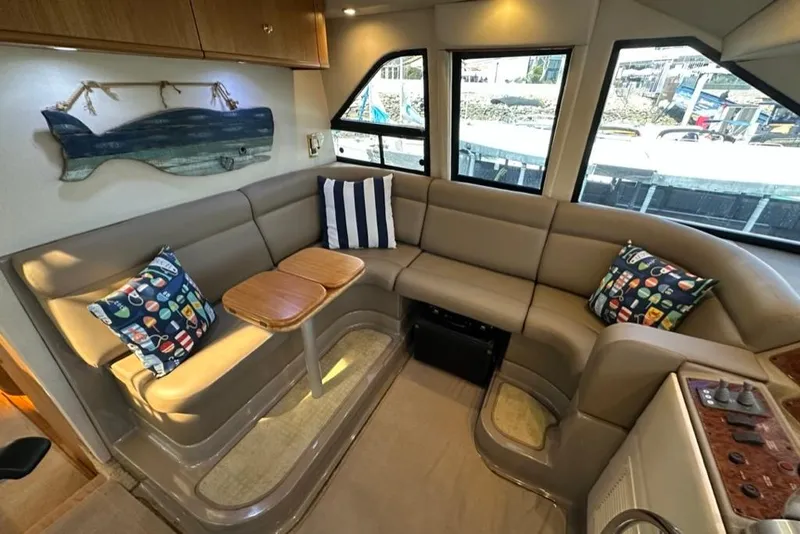 Slide: The Image of Luxurious interior of 1999 Bayliner 5788 Pilot House Motoryacht with plush seating and nautical decor. - 32