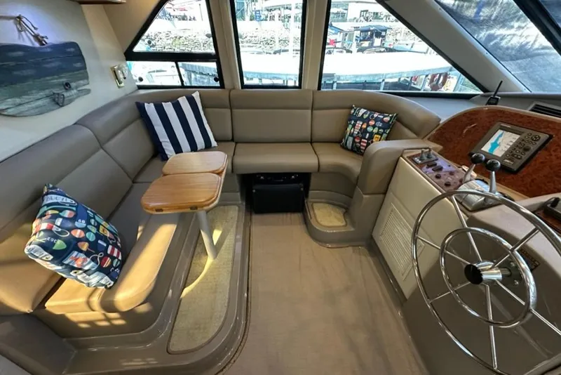 Slide: The Image of Luxurious interior of 1999 Bayliner 5788 Pilot House Motoryacht with plush seating and helm. - 33