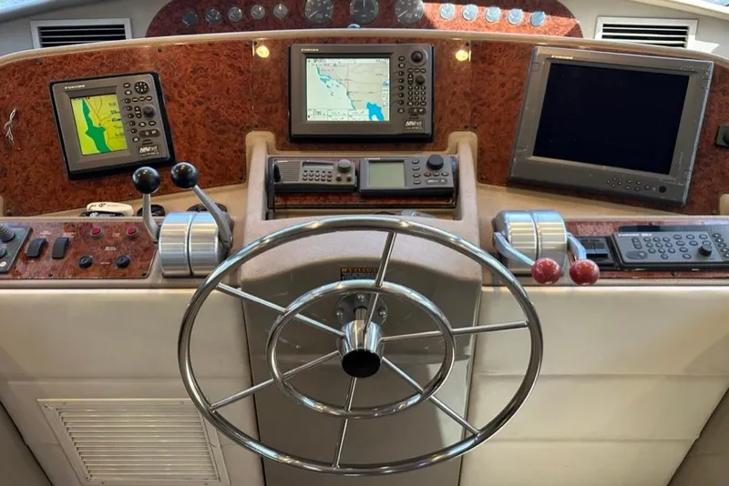 Slide: The Image of 1999 Bayliner 5788 Pilot House Motoryacht helm with navigation instruments and steering wheel. - 35
