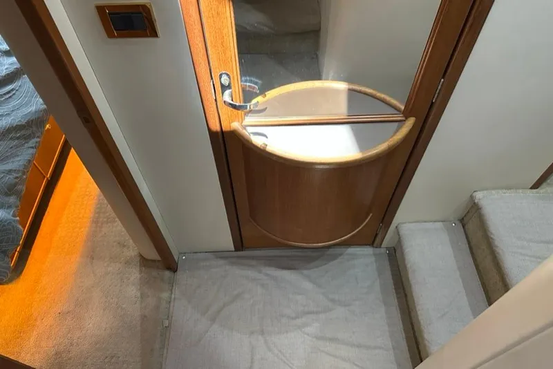 Slide: The Image of Interior of 1999 Bayliner 5788 Pilot House Motoryacht with wooden door and carpeted stairs. - 37