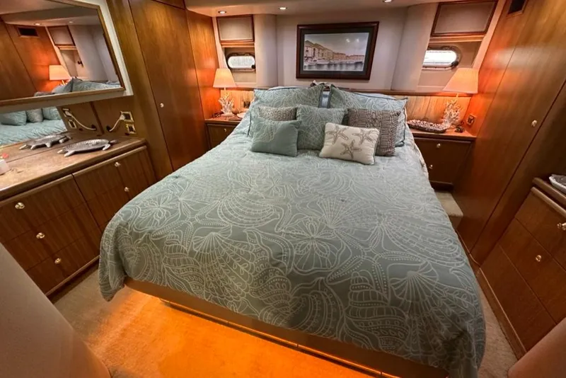 Slide: The Image of Luxurious bedroom interior of 1999 Bayliner 5788 Pilot House Motoryacht with elegant bedding and warm lighting. - 38