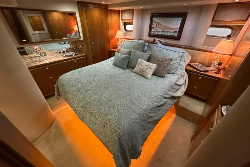 Slide: The Image of Luxurious bedroom interior of 1999 Bayliner 5788 Pilot House Motoryacht with elegant bedding and warm lighting. - 39
