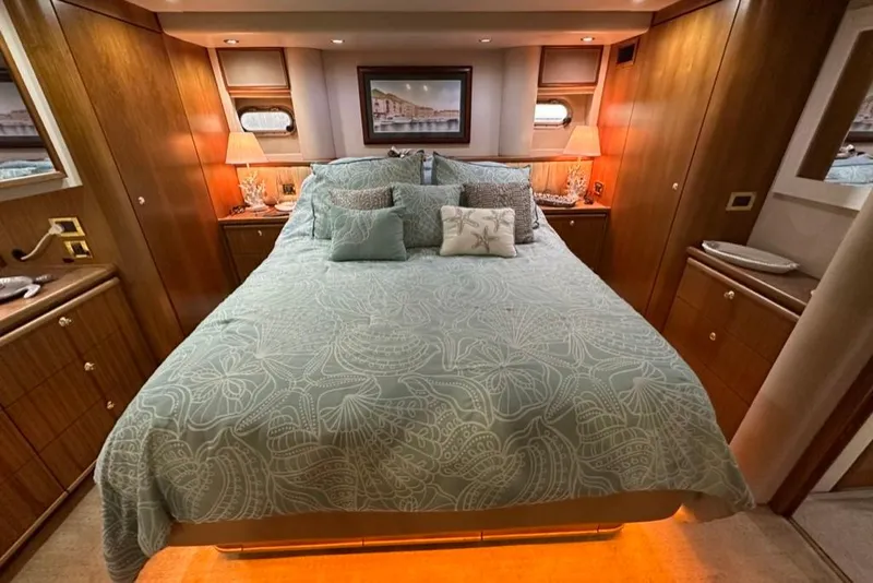 Slide: The Image of Luxurious bedroom in 1999 Bayliner 5788 Pilot House Motoryacht with elegant bedding and warm lighting. - 41